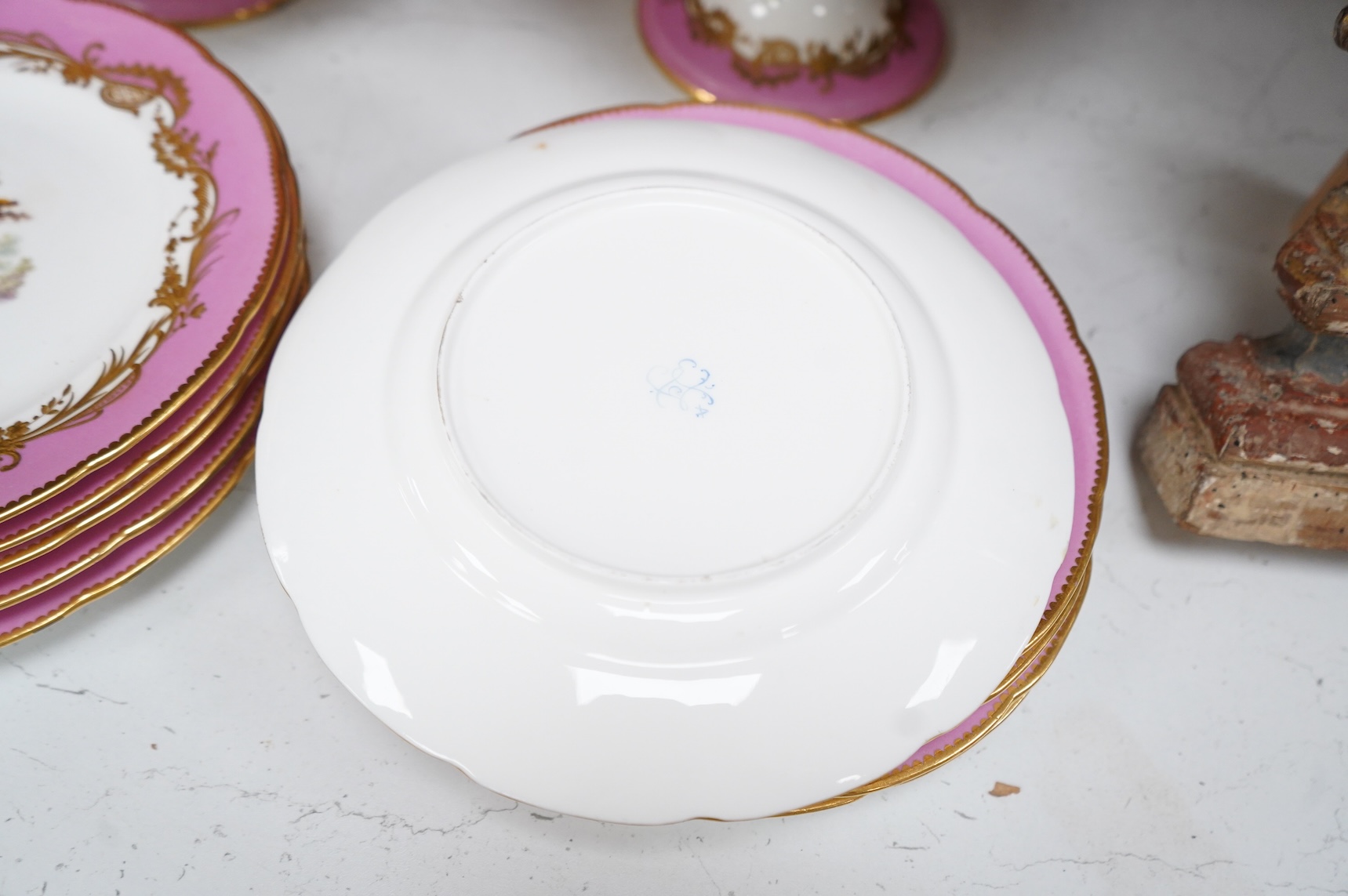 A Minton pink ground dessert service, in Sevres style, c.1850, hand painted with birds, comprising four comports and ten dessert plates, 23cm in diameter